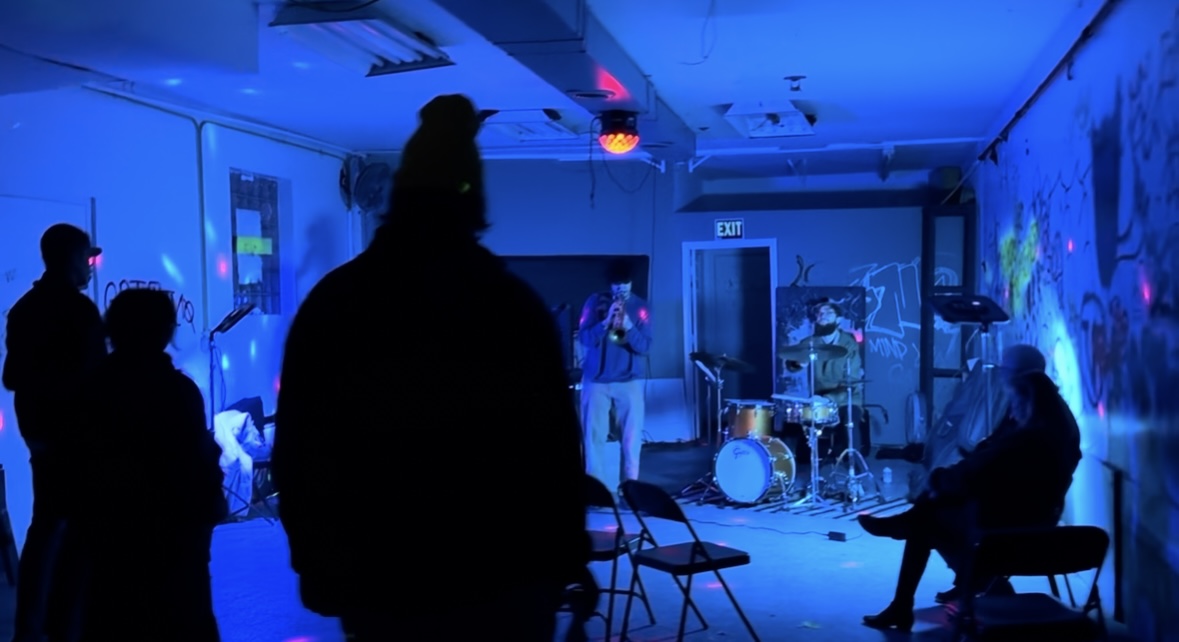 Band performing under blue stage lighting in a Chicago venue